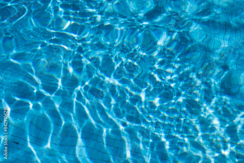 The texture of the water in the summer pool close-up.