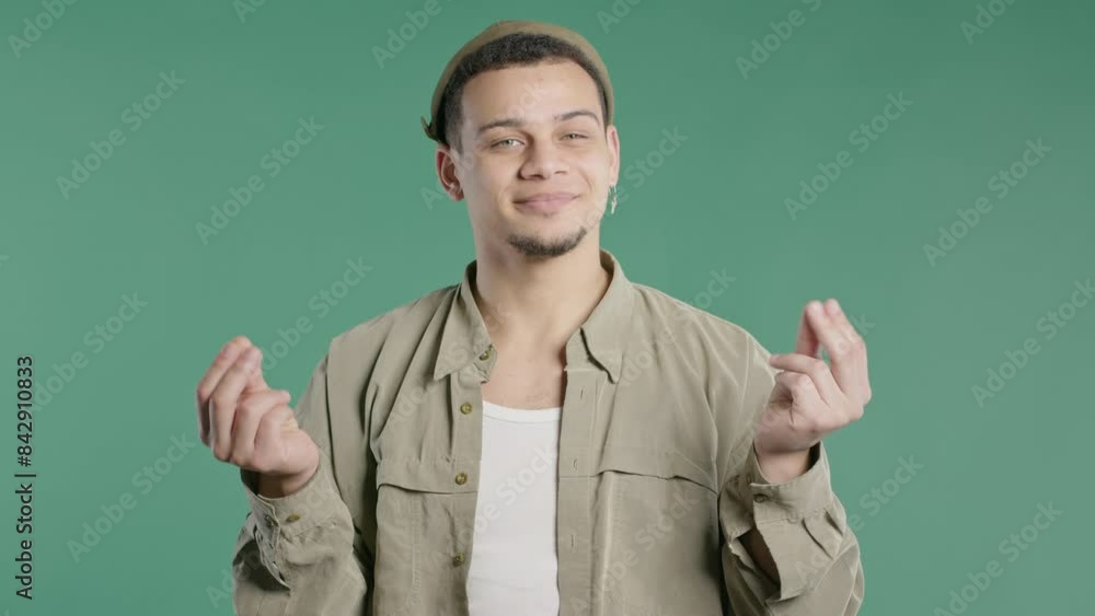 Smiling man asking money gesture on green studio background. Smart teenager dude Smiling man asking money gesture on green studio background. Smart teenager dude