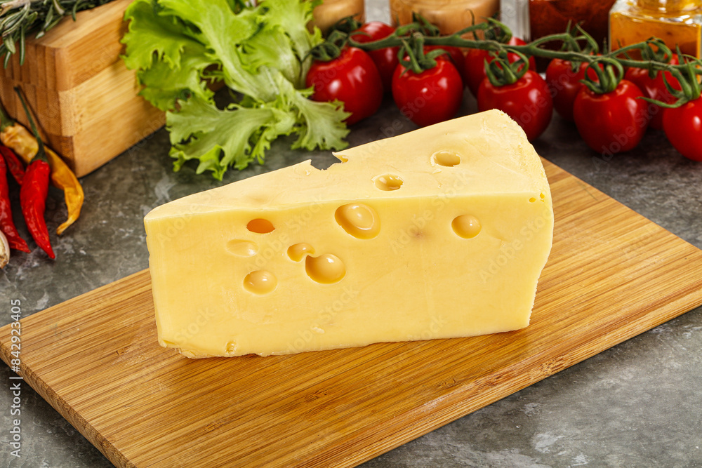 Swiss Maasdam cheese triangle over board Swiss Maasdam cheese triangle over board