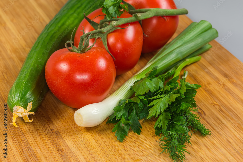 Various fresh vegetables and herbs on a wooden cutting board Various fresh vegetables and herbs on a wooden cutting board