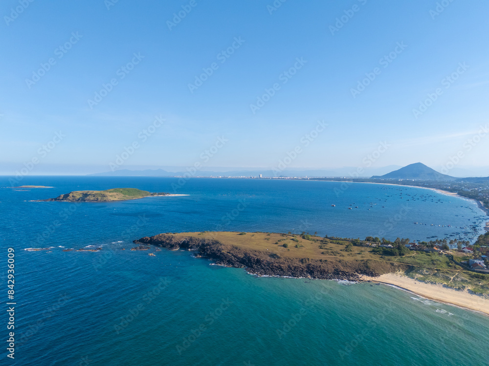 Obraz premium Aerial view of Bai Xep beach in Phu Yen province, Vietnam. Tropical coast from cliff above. Vietnam travel destination, golden sand beach waving sea rock boulders.