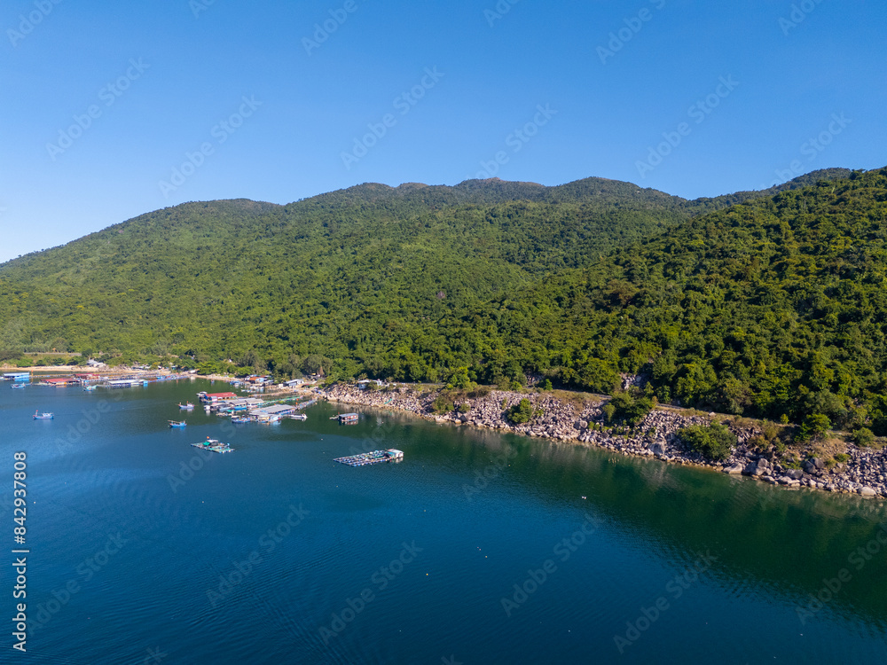 Fototapeta premium Aerial view of the lobster feeding farms, float fishing village in Vung Ro bay, Phu Yen, Vietnam. This is a very popular tourist destination.