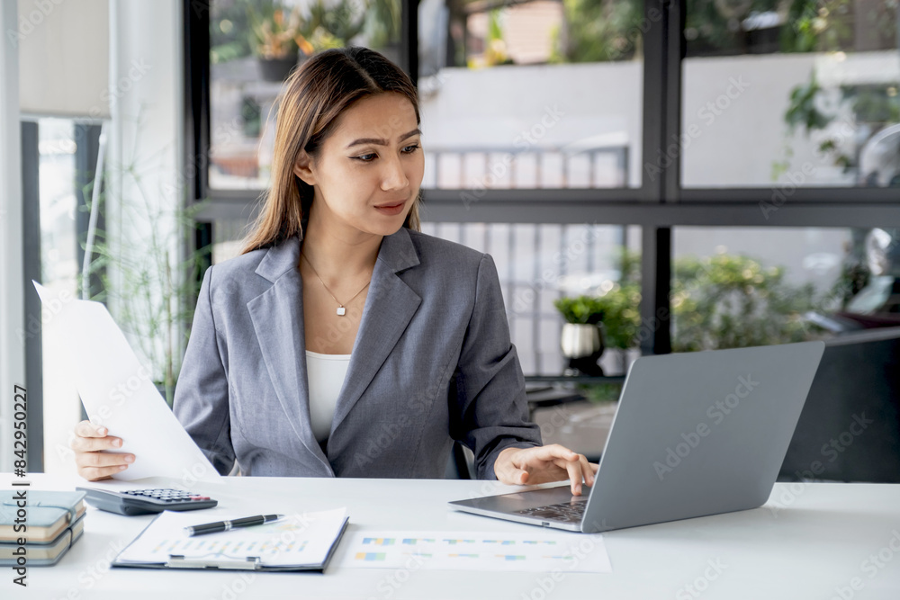 Businesswomen bookkeeper use laptop analysis the graph for Setting challenging business goals and ready to achieve target at home office Businesswomen bookkeeper use laptop analysis the graph for Setting challenging business goals and ready to achieve target at home office