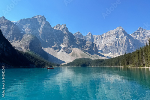 View from a boat to the mountains on Moraine Lake in the morning. Moraine Lake, Banff. © Alla