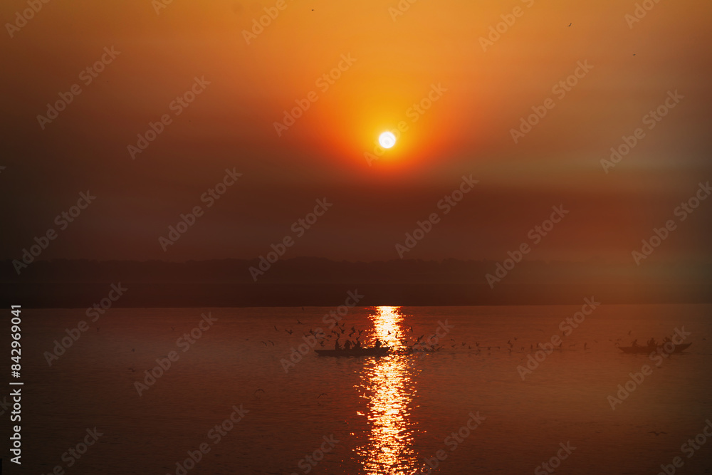 Fototapeta premium Boats during sunset. Dawn on sacred river Ganges in Varanasi, India