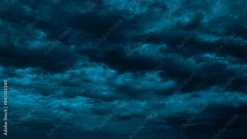 Night sky with clouds. Black dark petrol blue tone. Dramatic background. Storm thunder rain cloudy gloomy. Moonlight midnight. Scary creepy ominous. Mystical or horror war concept.