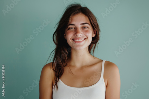 A close up portrait of a young woman with a subtle smile