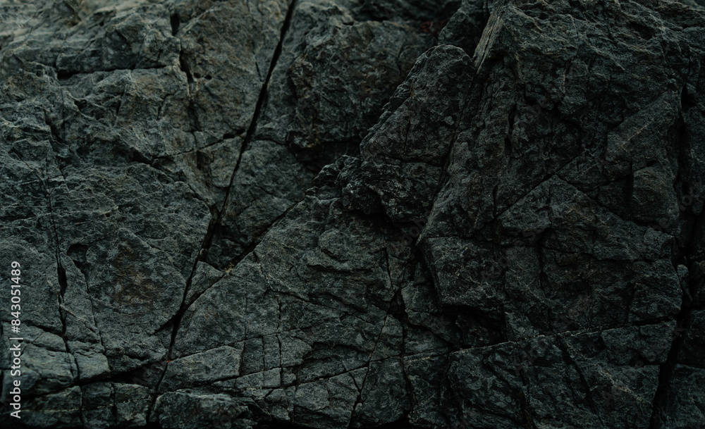 Black stone background. Dark rock surface texture at coast near the sea. Abstract pattern. Natural backdrop. Natural rock surface. Element, material design. Black stone background. Dark rock surface texture at coast near the sea. Abstract pattern. Natural backdrop. Natural rock surface. Element, material design.