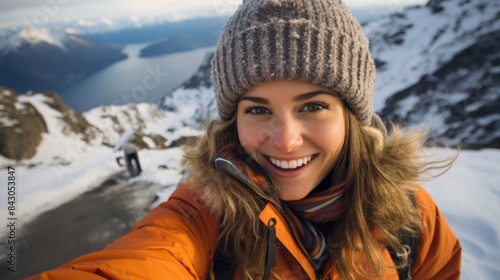 Joyful Adventurer Capturing a Selfie on Snowy Mountain Summit