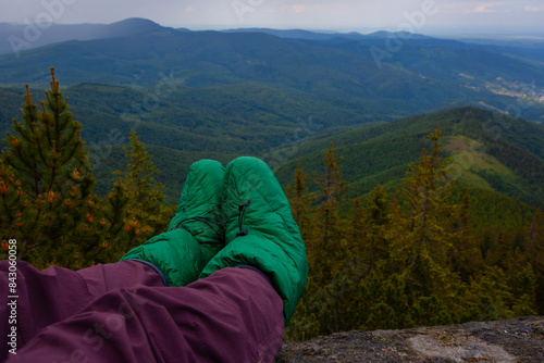 Legs in Downy booties socks  on the rock in Carpathian mountains © Alexandra Lande
