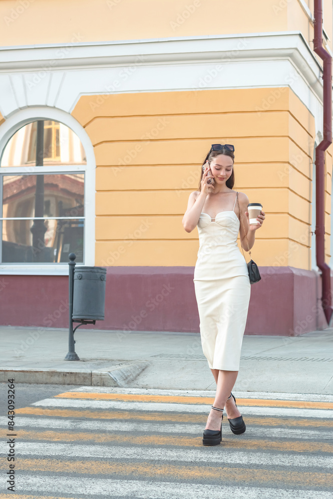 The girl walks around the summer city. The girl walks around the summer city.