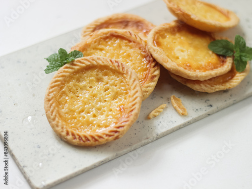 Cake of pie. Custard tarts or Pie Susu on marble board . selective focus with shiny and rough rexture photo