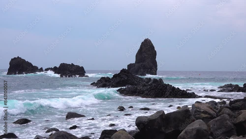 Mediterranean Sea waves crashing on the volcanic rocks of Mount Etna in Catania Sicily shores. Mediterranean Sea waves crashing on the volcanic rocks of Mount Etna in Catania Sicily shores.