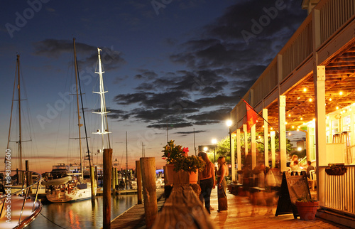 Restaurants and boats along the boardwalk at night in downtown Beaufort North Carolina photo