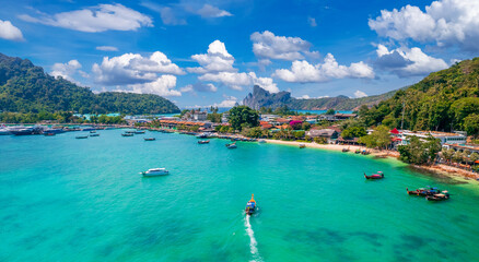 Island Phi Phi with longtail boat, turquoise clear water in Krabi Thailand. Amazing travel landscape photo in Thai