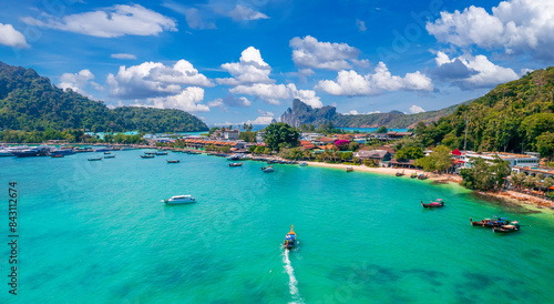 Island Phi Phi with longtail boat, turquoise clear water in Krabi Thailand. Amazing travel landscape photo in Thai
