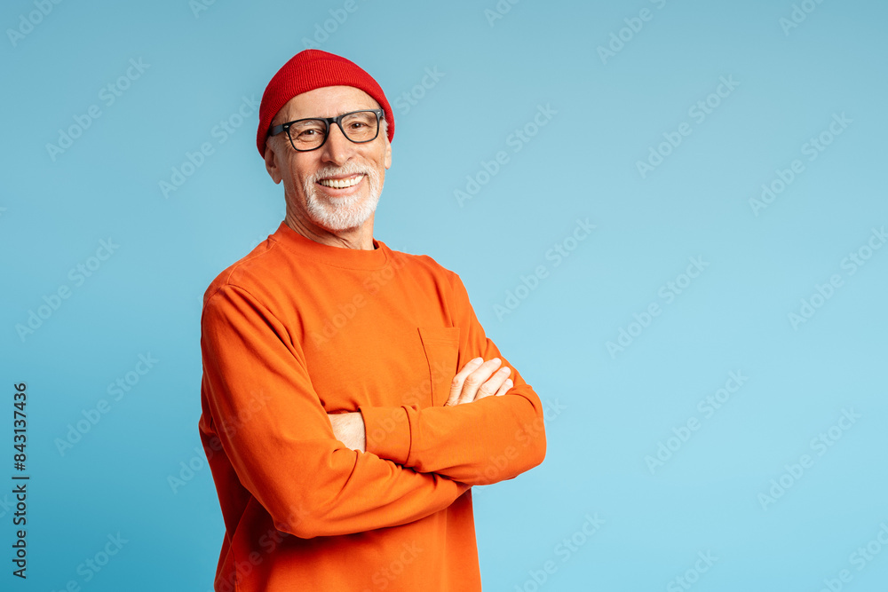 Portrait of grey haired smiling senior man with arms crossed posing isolated Portrait of grey haired smiling senior man with arms crossed posing isolated