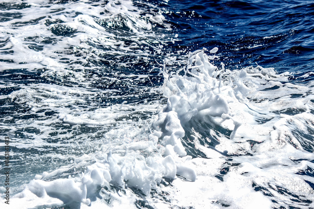 White sea waves foam on the blue sea. White sea waves foam on the blue sea.