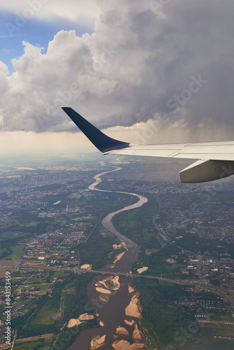 Obraz na płótnie Plane flying over the city of Warsaw, Poland with visible Vistula river w salonie