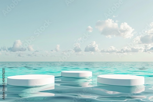 three round white podiums on turquoise water
