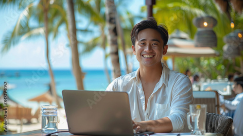 Wallpaper Mural handsome asian man in casual working on laptop from resort on a beach, digital nomad, workation Torontodigital.ca