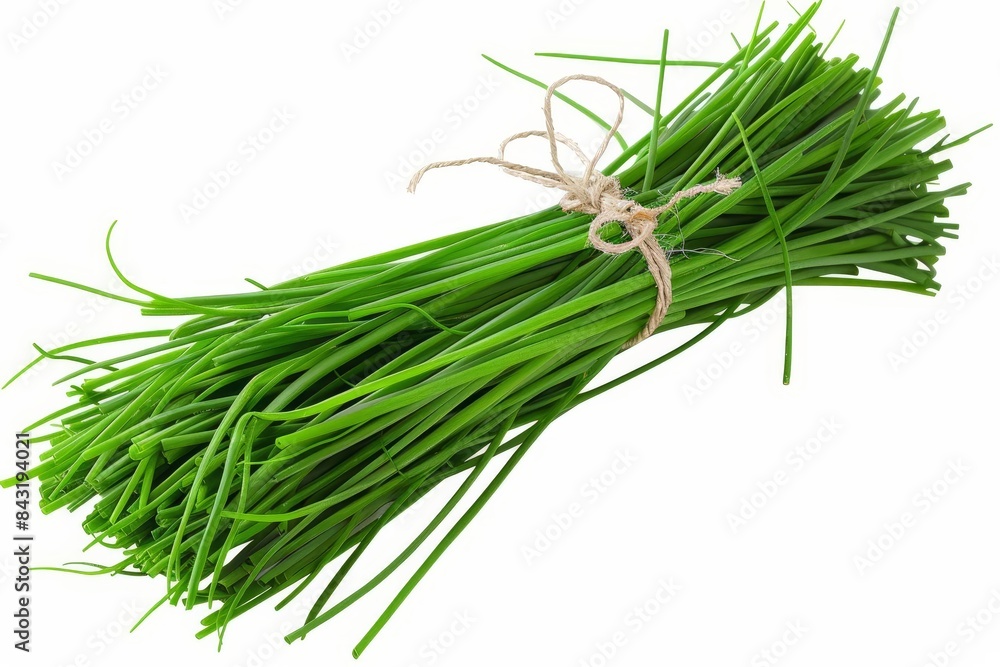 A fresh bunch of chives with slender green stems and a mild onion ...