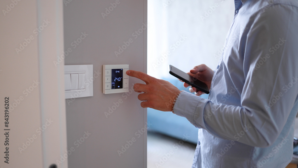 Man using smart home technology at his apartment Man using smart home technology at his apartment