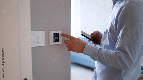 Canvastavla Man using smart home technology at his apartment