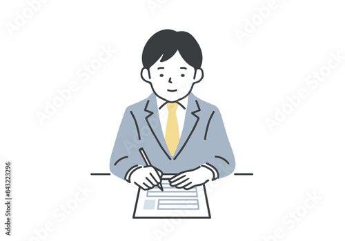 履歴書を書くスーツを着た男性