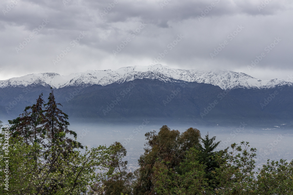 A freezing day high in the Andes Mountains in Chile, with mountains covered in snow.
