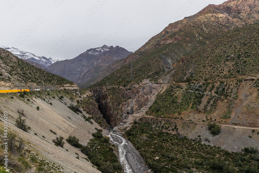 A freezing day high in the Andes Mountains in Chile, with mountains covered in snow.