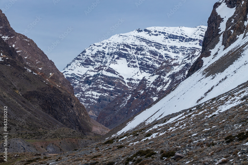 A freezing day high in the Andes Mountains in Chile, with mountains covered in snow.