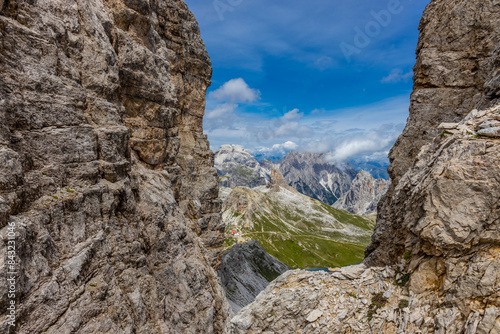 Dolomites, Alpi Dolomiti beautiful scenic mountain landscape under blue sky in summer. Rocky tower peak summits of the Alps on a sunny day. Alpine scenic view of the cliffs and climbing walls in Italy