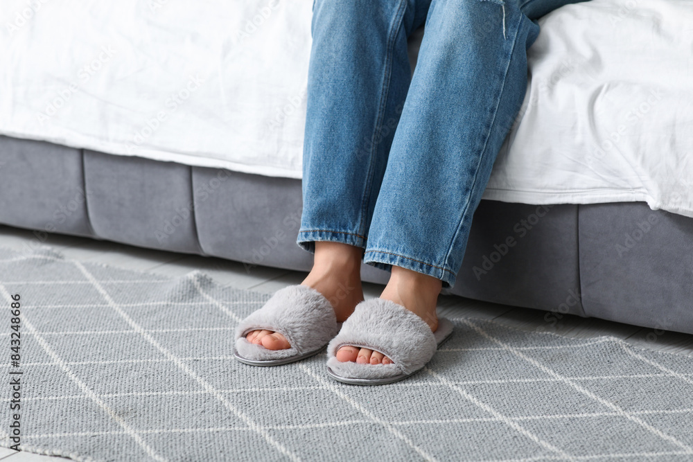 Female legs in stylish slippers in room Female legs in stylish slippers in room