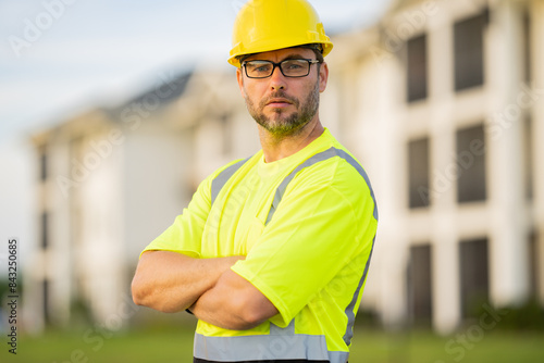 A construction worker in highvisibility gear emphasizes safety and professionalism at a dusty work site photo