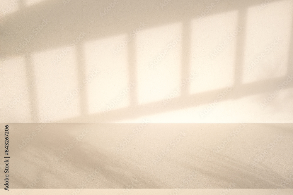 Wall interior background, studio and backdrops show products. with leaf shadow from window color beige and white. background for text insertion and presentation of product Wall interior background, studio and backdrops show products. with leaf shadow from window color beige and white. background for text insertion and presentation of product