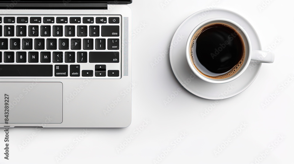 overhead view of open laptop at 33 degree angle, brightly lit, white background with coffee mug on table overhead view of open laptop at 33 degree angle, brightly lit, white background with coffee mug on table
