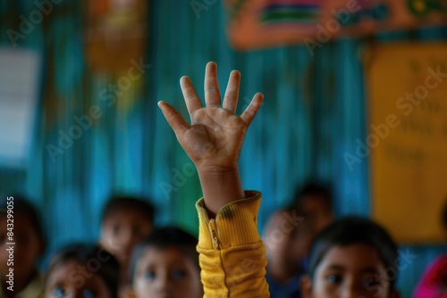 Close up of elementary student hands raised hand for answering question or asking question or voting or volunteering for helping teacher. Diverse children putting hands in the air at classroom. AIG42.