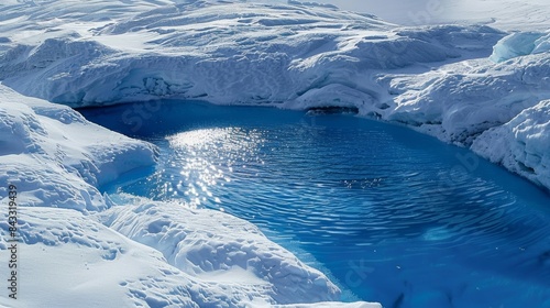 Splashes of bright blue a the white expanse signify the presence of supraglacial lakes. photo