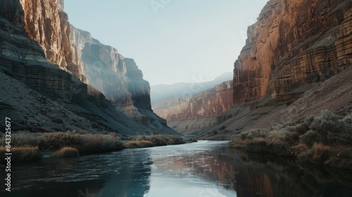 A tranquil river winding through a canyon with steep cliffs rising on either side, Symbolizing strength and resilience