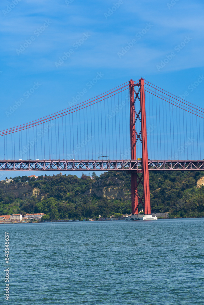 Obraz premium The 25th April Bridge, Ponte 25 de Abril in Portuguese, the longest suspension bridge in Europe. Connecting the city of Lisbon, capital of Portugal, to the municipality of Almada over the Tagus River.