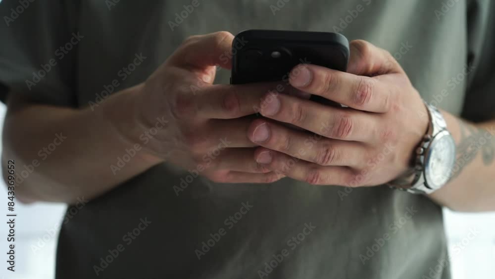a guy in a green T-shirt is holding a phone in his hands.
The phone is in the hands of a man.
Smartphone screen clicks a guy in a green T-shirt is holding a phone in his hands.
The phone is in the hands of a man.
Smartphone screen clicks