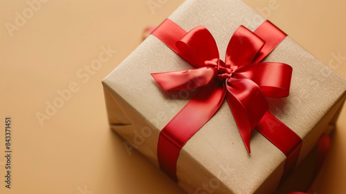beige paper box with red ribbon