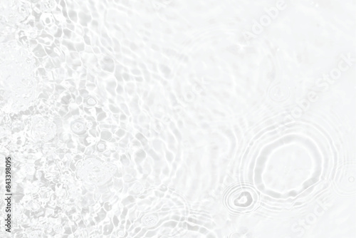 White water with ripples on the surface. Defocus blurred transparent white colored clear calm water surface texture with splashes and bubbles. Water waves with shining pattern texture background.