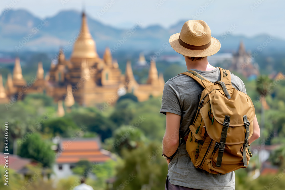 Back view of a traveler man with backpack at Myanmar ancient pagoda Back view of a traveler man with backpack at Myanmar ancient pagoda