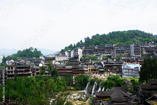 Cityscape historic building antique architecture of Furong Zhen Tujia ancient town with landscape mountain waterfall and youshui river for chinese travelers travel visit on May 9, 2024 in Hunan, China photo