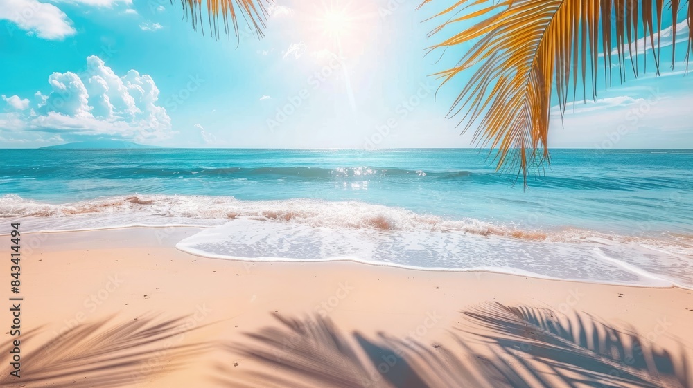 Fototapeta premium Summer background with frame, nature of tropical golden beach with rays of sun light and leaf palm. Golden sand beach close-up, sea water, blue sky, white clouds. Copy space, summer vacation concept.