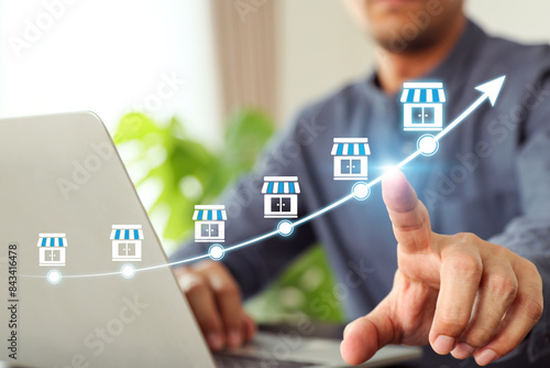 Cuadro en lienzo Hand choose franchise business store on arrow graph for franchising goal to growth branch expansion and business banking loan or consumer resources service