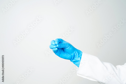 hand gestures or signs in blue disposable latex surgical gloves isolated