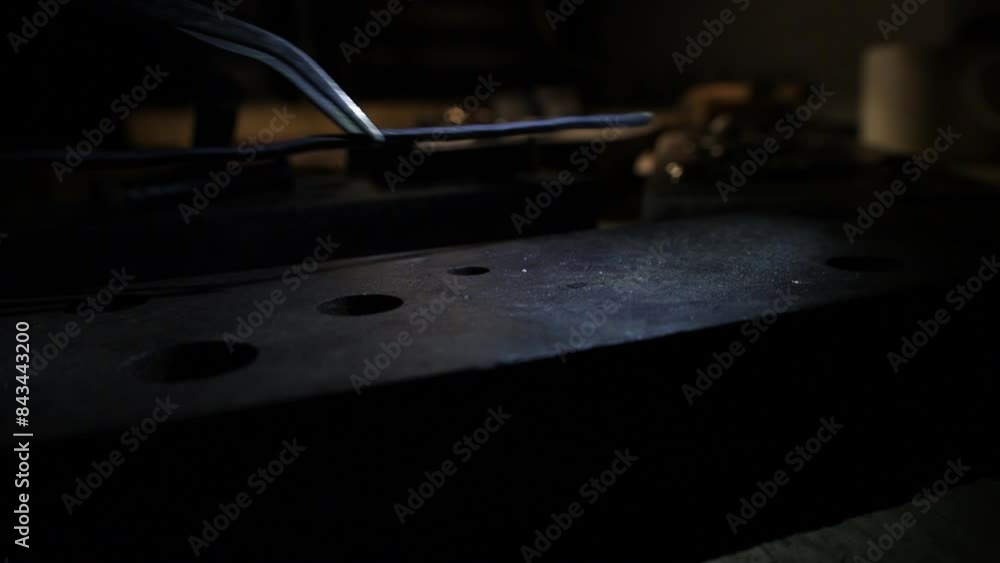 jeweler puts heated metal close up to cool jeweler puts heated metal close up to cool